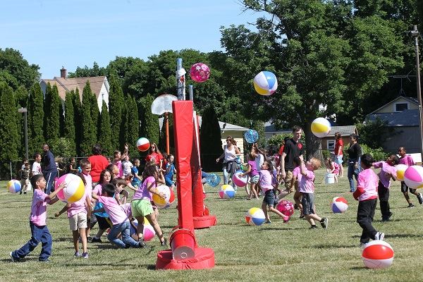 Kids Playing with Beach Balls in Park